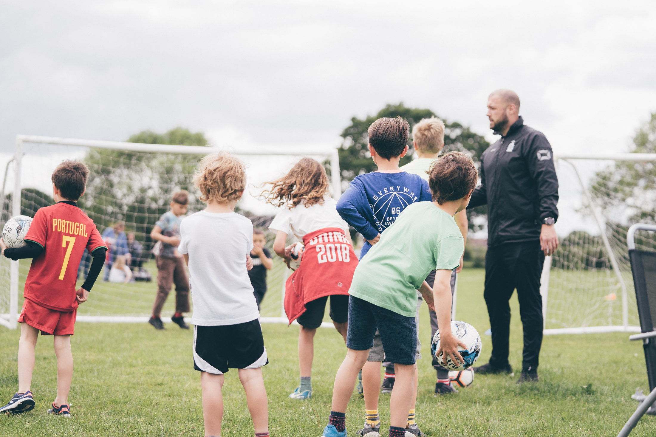 A Soccer Stars coach working with a small group